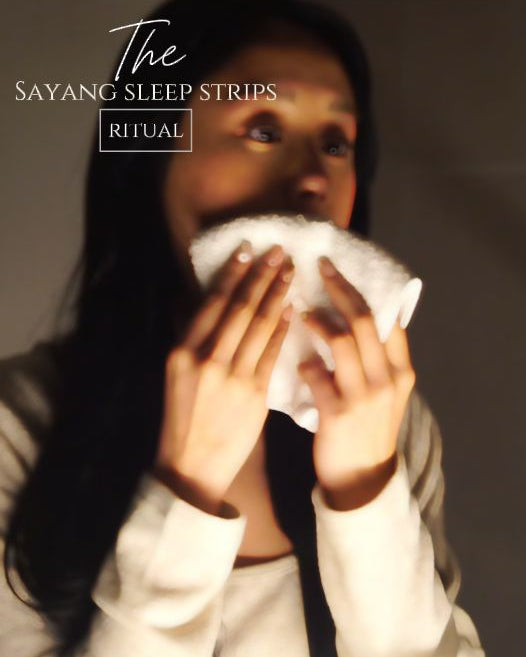 Woman smells a Sayang Sleep Strip, applies the scented mouth tape before bed, sleeps wearing it, then places the used strip into the Your Sayang Journey booklet in the morning.