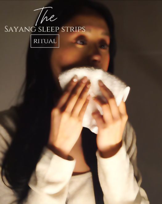 Woman smells a Sayang Sleep Strip, applies the scented mouth tape before bed, sleeps wearing it, then places the used strip into the Your Sayang Journey booklet in the morning.