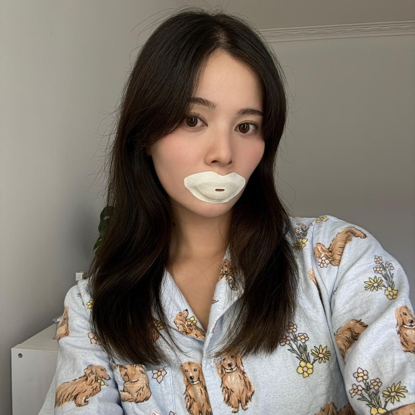Woman wearing a Sayang Sleep Strip with pyjamas for her nighttime routine, featured with a testimonial about feeling relaxed before sleep.